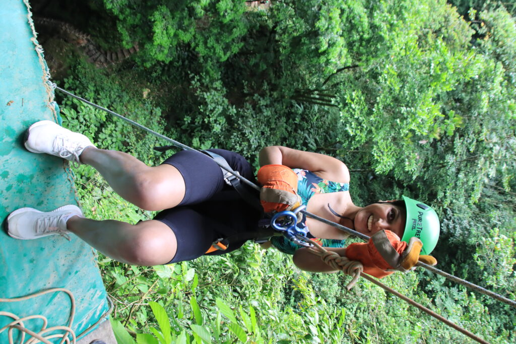 Vanisha strapped in to a harness and about to go abseiling