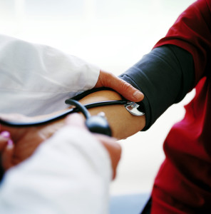 Doctor Checking the Blood Pressure of a Patient --- Image by © Royalty-Free/Corbis