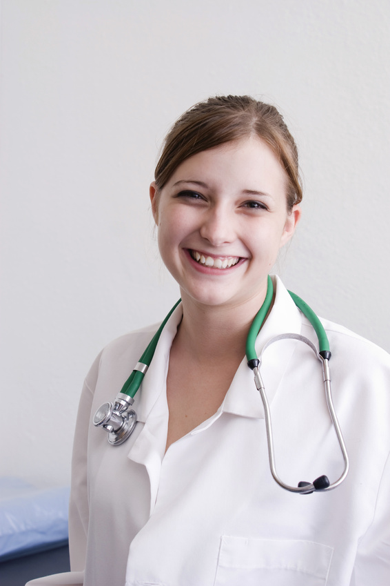Young, smiling female doctor in a white coat.