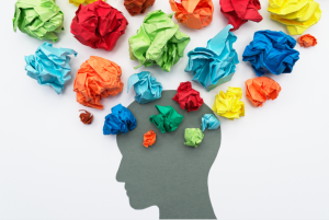 An illustration of a silhouetted head with balls of colourful scrunched paper coming out of the top.